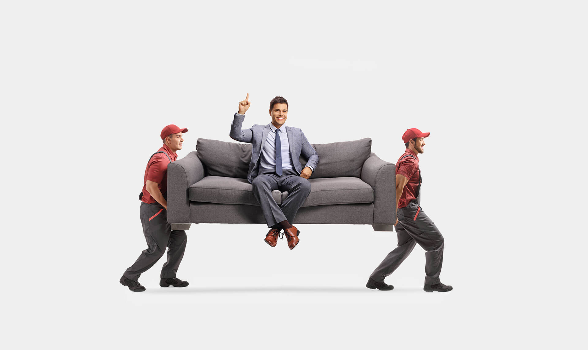 Umzug Schweiz Berlin – zwei Träger heben Sofa mit Geschäftsmann